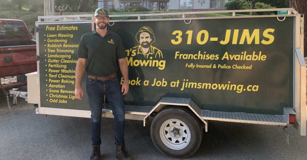Daniel Black our Jim’s Mowing franchisee in Downtown Kelowna and West Kelowna in front of trailer